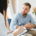 Addiction psychiatrist taking notes while talking with a patient during a consultation