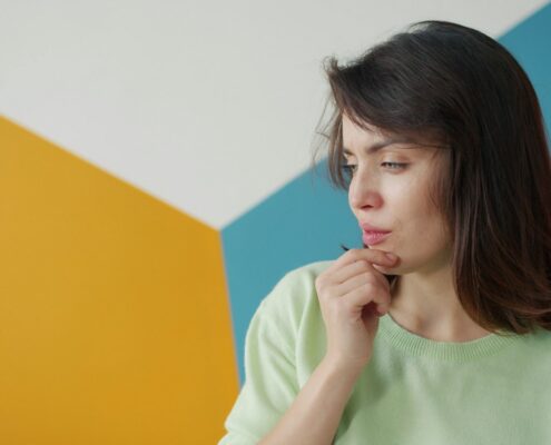 Young woman looking away nervously, a common sign of social anxiety