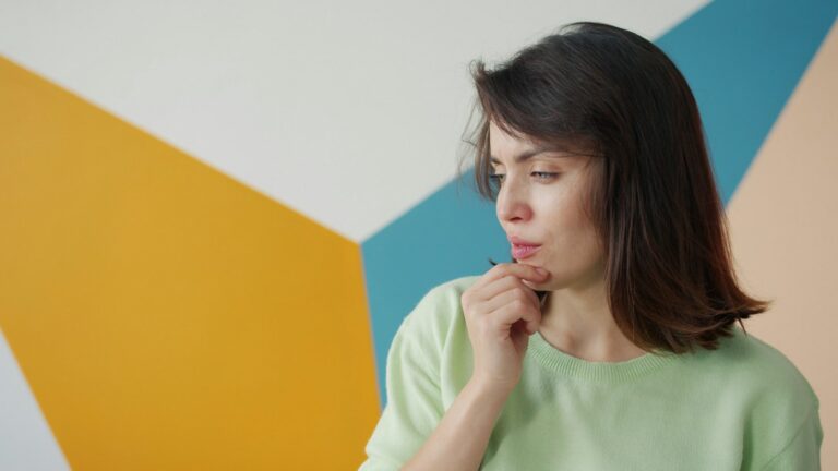 Young woman looking away nervously, a common sign of social anxiety